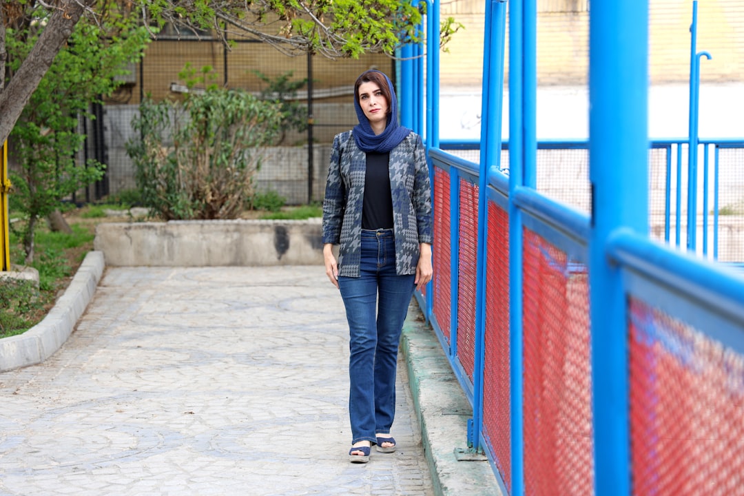 Woman walking on a path with blue railing